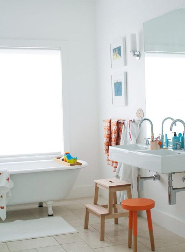 Sunlit White Bathroom With Orange Accents