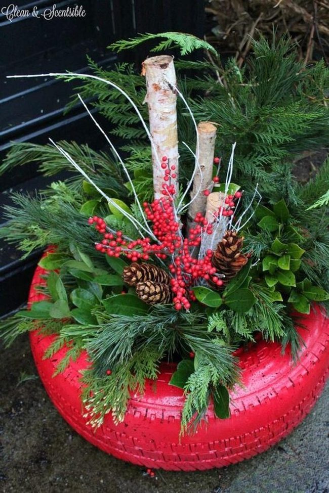 Red Tire Planter With Seasonal Blooms