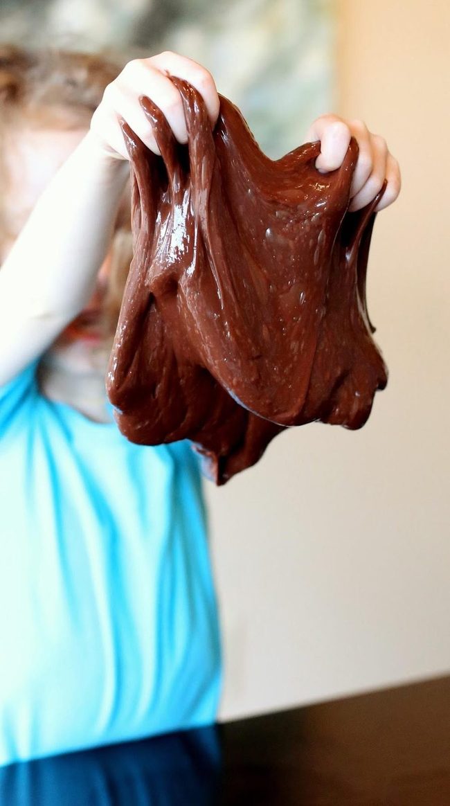 Brown Slime Stretches Between Small Hands
