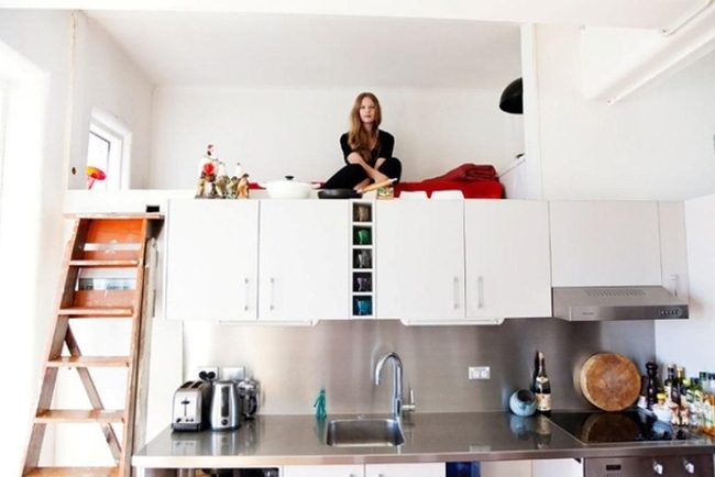 Sunlit White Kitchen With Perched Figure
