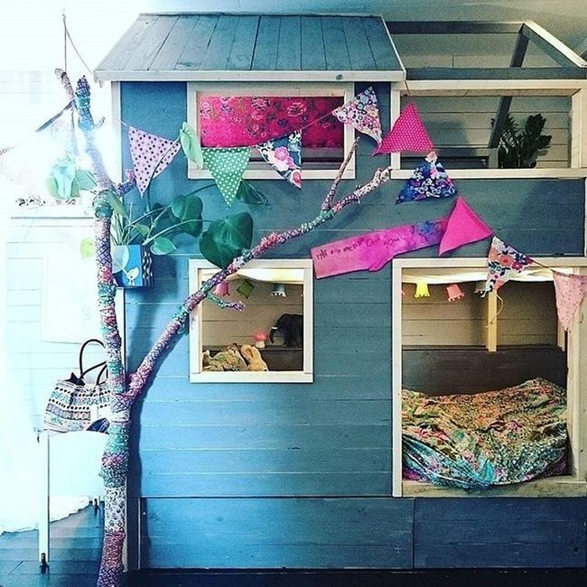 Blue Wooden Playhouse With Rainbow Flags