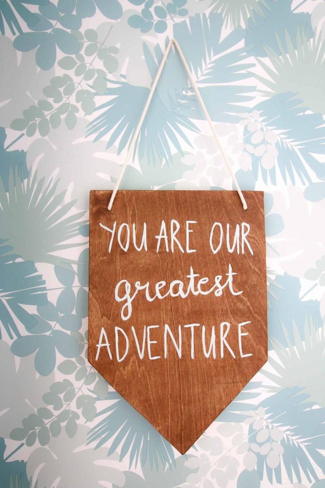 Light Blue Leafy Wall With Wooden Sign