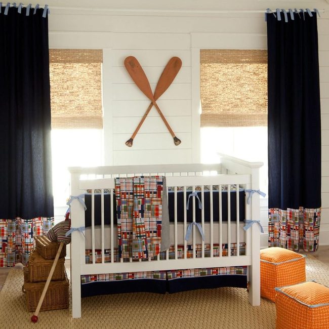 White Nursery With Navy Curtains And Orange Poufs