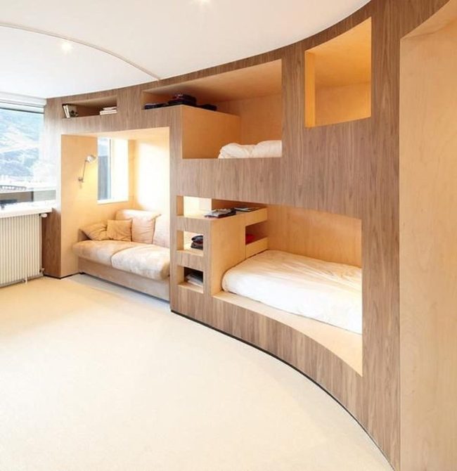 Curved Wood Wall With Built-In Beds