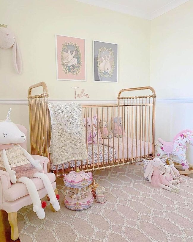 Brass Crib Against Pink Walls