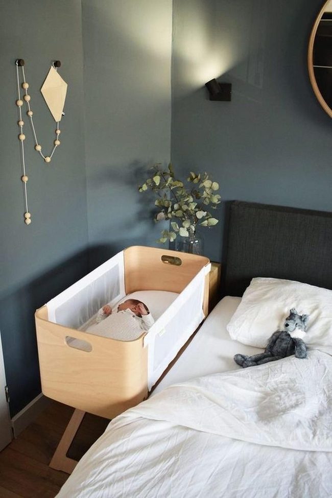 Grayish-Blue Nursery With Wooden Bassinet