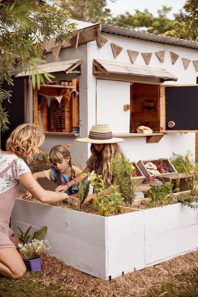White Garden Shed With Flowers