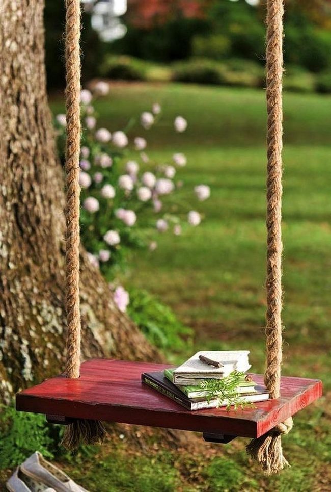 Red Swing Among Green Leaves