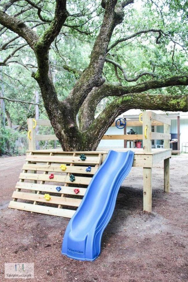 Wooden Treehouse With Colorful Climbing Grips