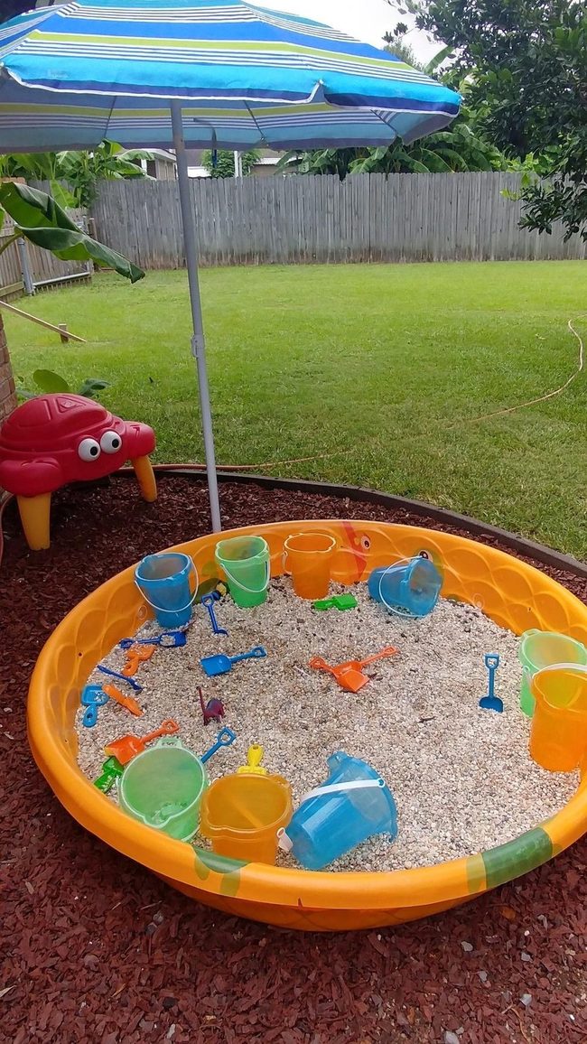 Sunny Sandbox With Striped Umbrella