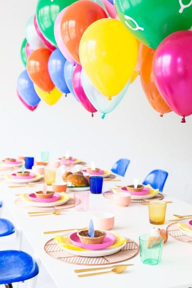 Balloon-Filled Table With Candlelit Cakes