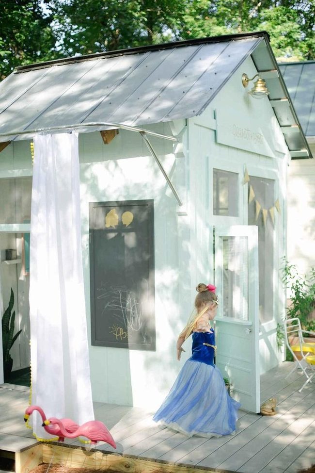 White Playhouse Among Green Trees