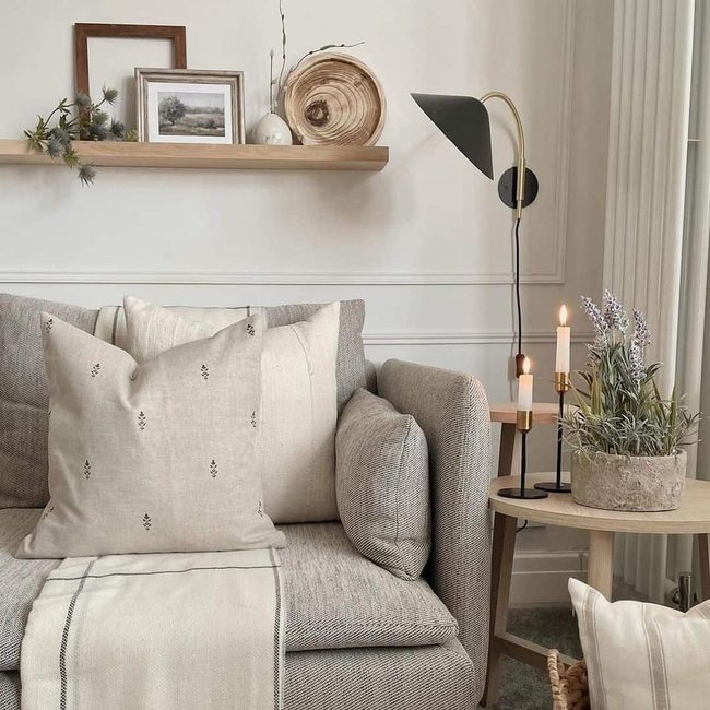 White Wall, Gray Couch, Purple Flowers