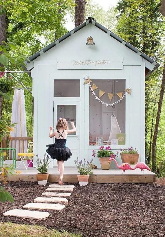 White Playhouse Among Green Trees