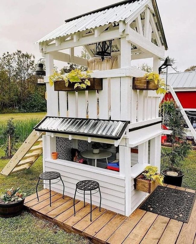 White Playhouse With Flowering Window Boxes