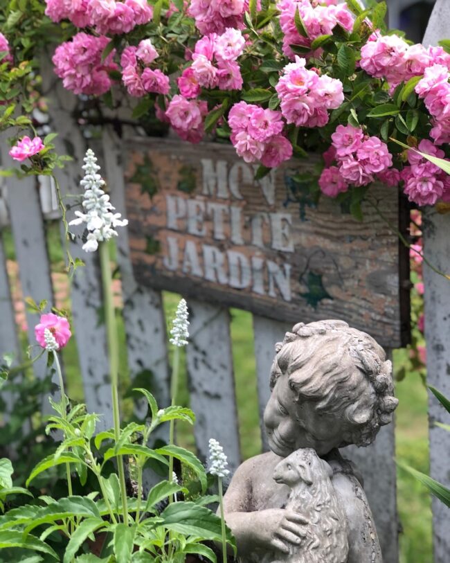 Charming Garden Statue Amidst Flowering Oasis